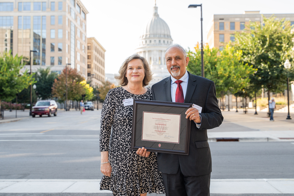 Harry Sharata poses with his award and his wife