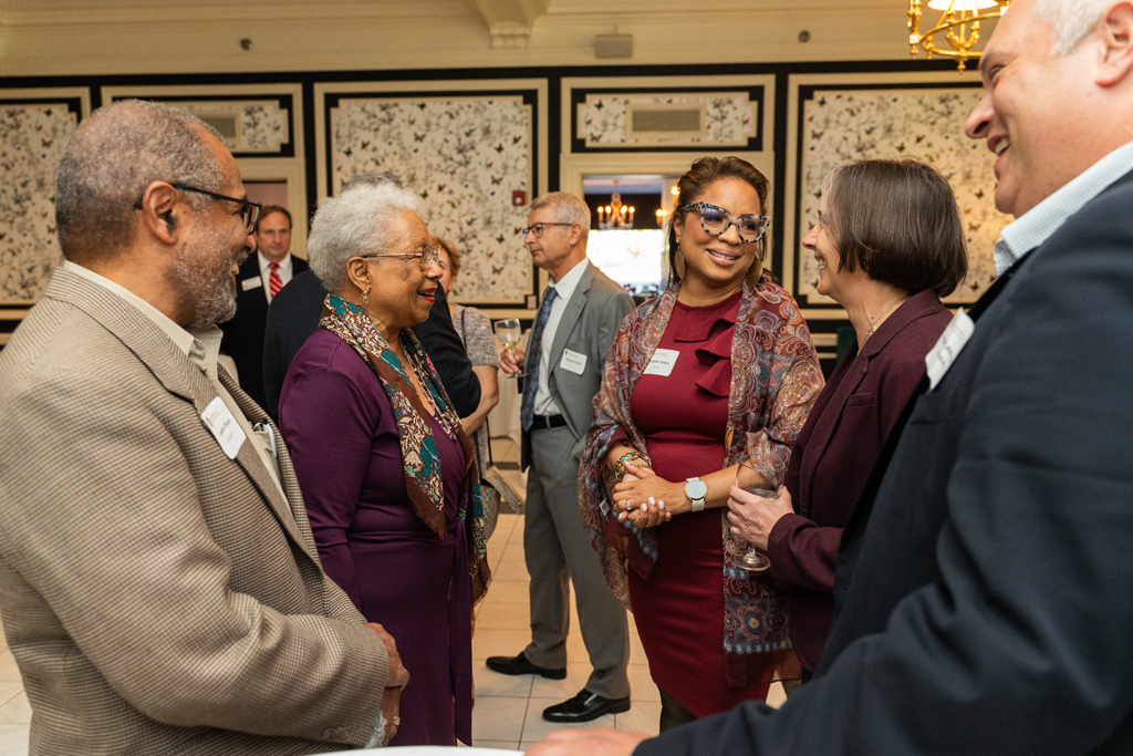 Yolanda Tolson speaks with Lynne Taylor and other attendees.