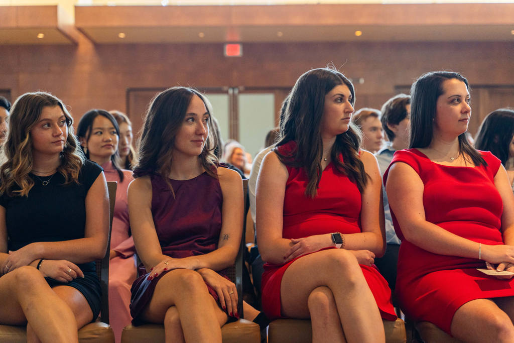 Students sit and listen to speakers