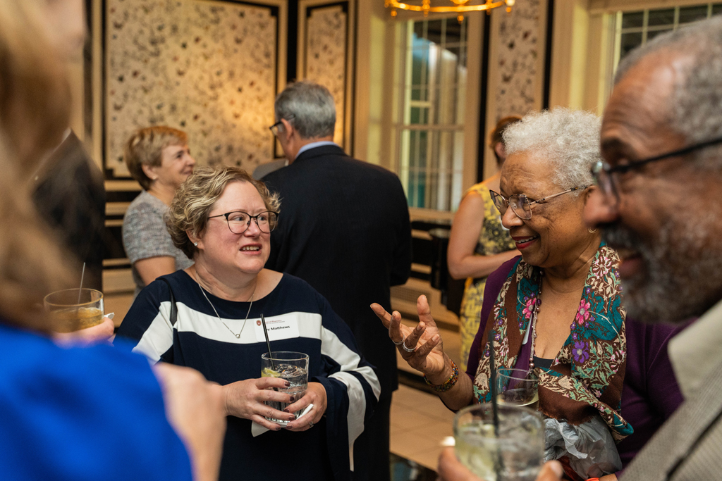 Joy Matthews speaks with two other attendees.