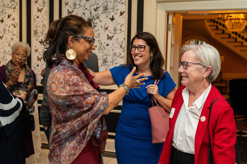 Yolanda Tolson and Lisa Imhoff appear ready to hug next to Jeanette Roberts.