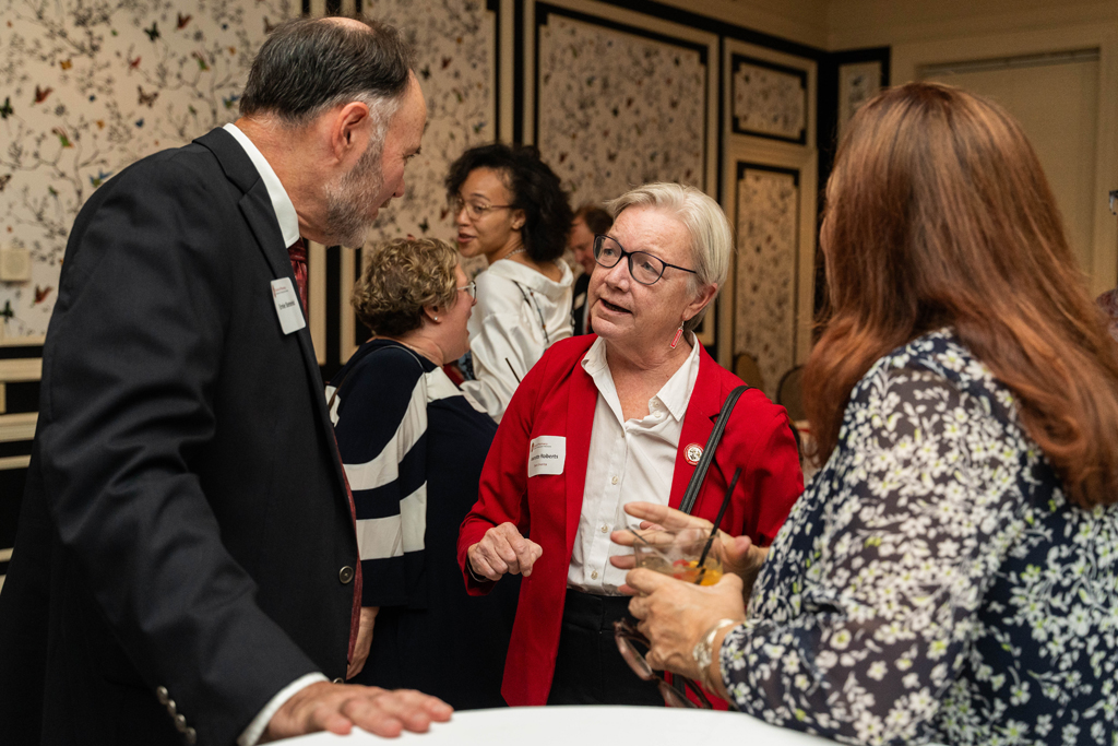 Jeanette Roberts speaks with two attendees.