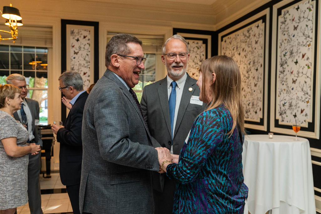 Steve Skolaski, Ralph Middlecamp, and another female attendee speak.