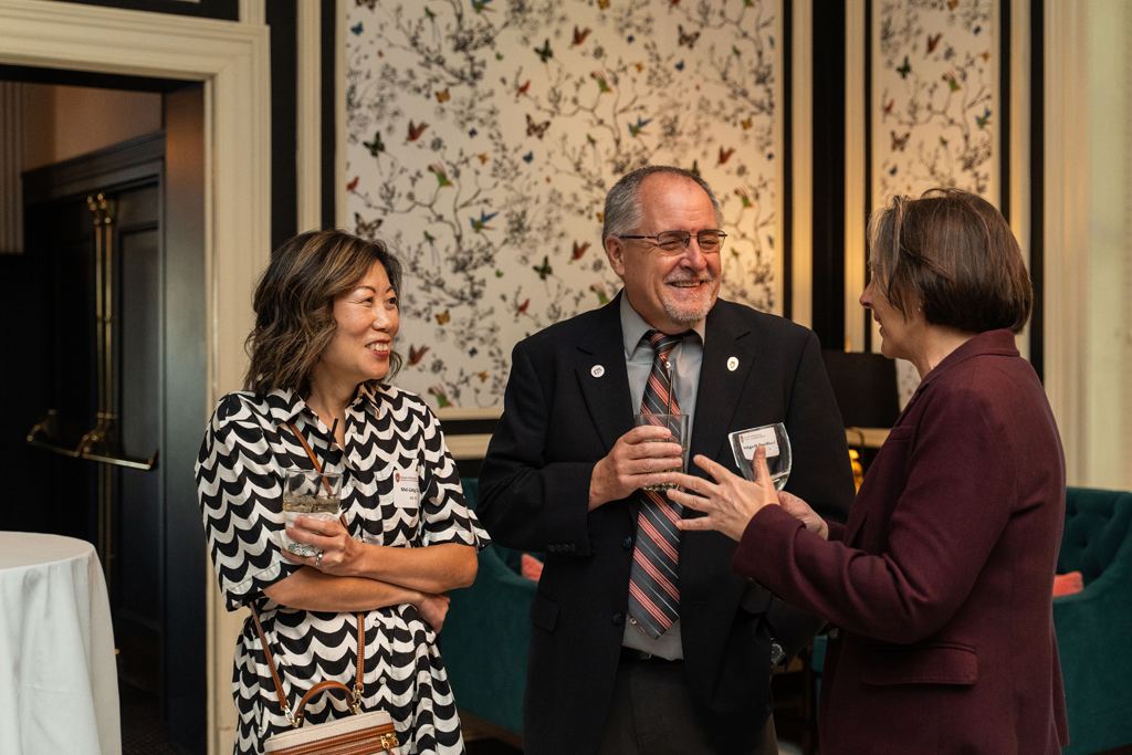 Mel de Villiers, Lynne Taylor, and another attendee laugh in conversation