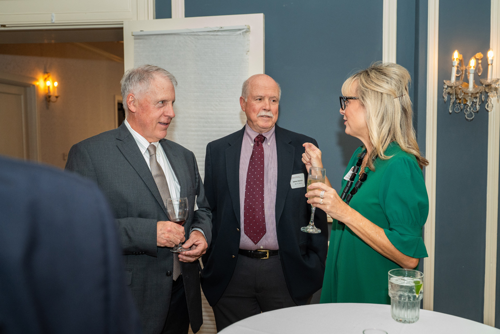 Eugene McNally, James DeMuth, and Beth Martin speak together at a table