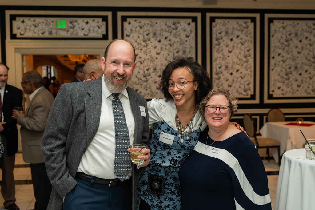 Joy Matthew, Dakotah Eveans and another attendee psoe for a photo.