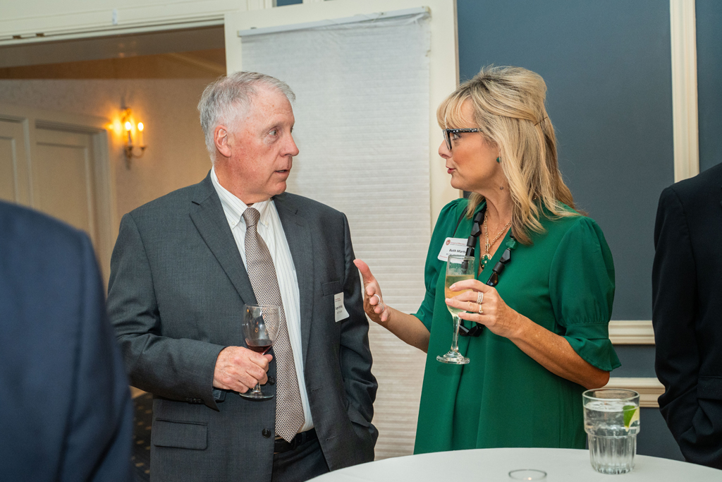 Eugene McNally and Beth Martin speak at a table