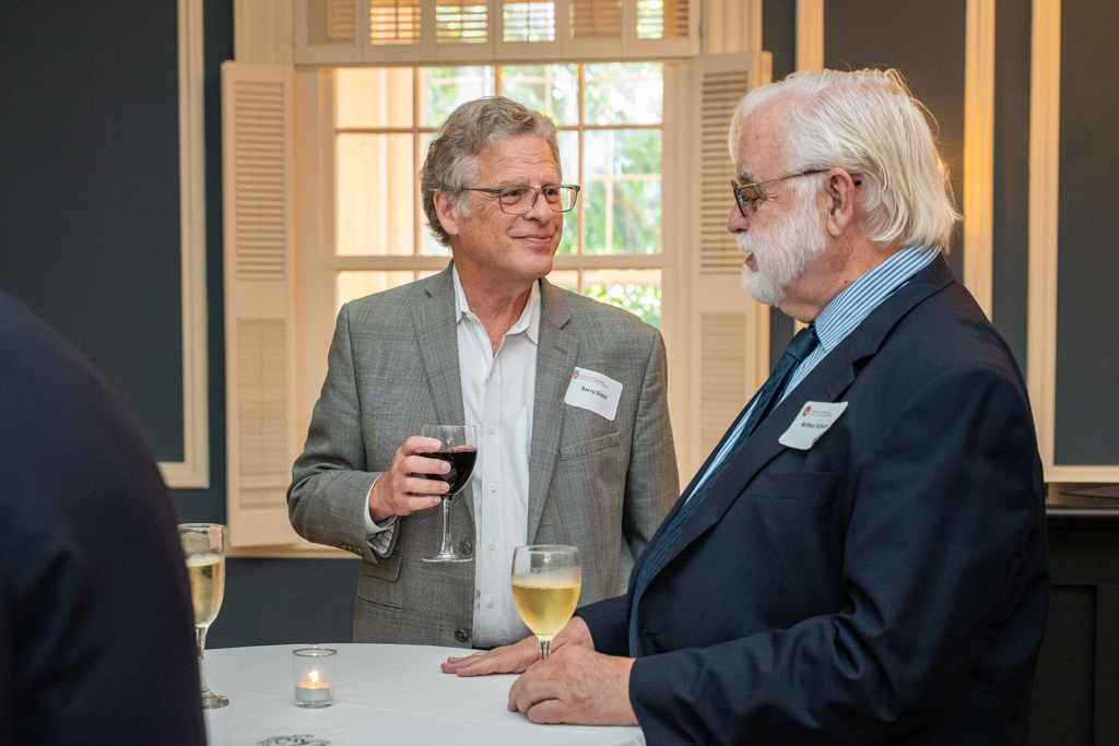 Barry Gidal and Arthur Schuna speak at a table