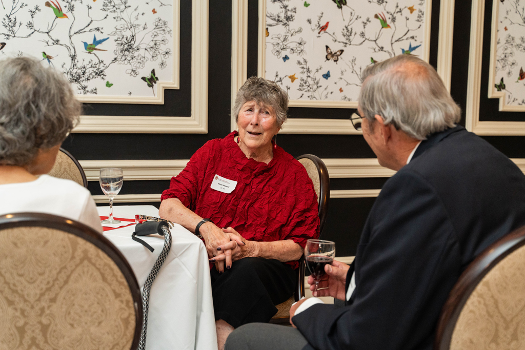 Pam Ploetz has an animated conversation with Gary Girdakis.