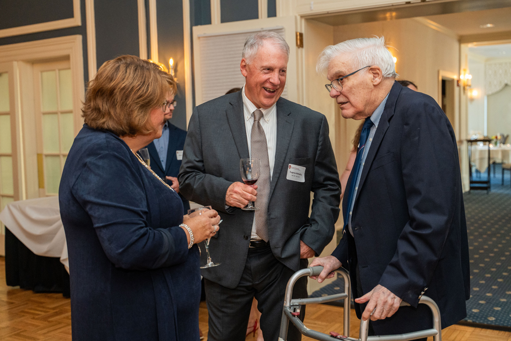 Eugene McNally speaks with George Zografi and another attendee.