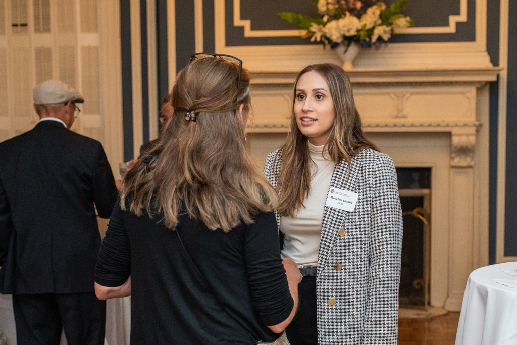Madeline Sharata speaks with another attendee