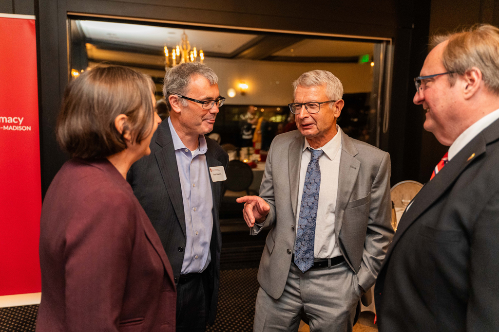 Evgenyi Shaelev speaks with Dean Steve Swanson, Lynne Taylor, and another attendee.