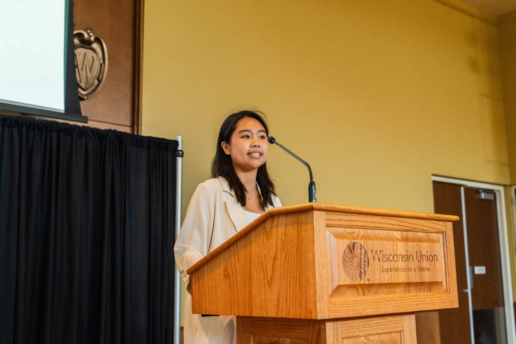 A female student speaks at a podium