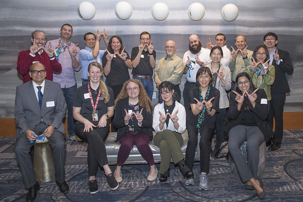 A group of Pharmaceutical Sciences Badgers holding up "W" hands for Wisconsin.