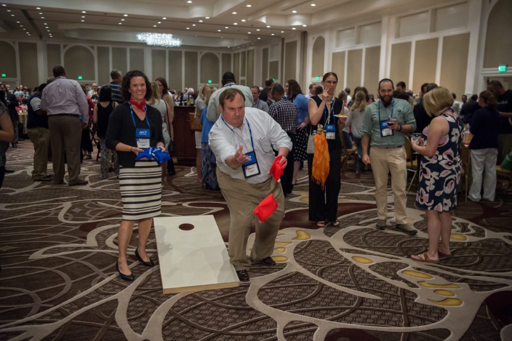 Dean Steven Swanson (right) enjoys some downtime at the AACP meeting with a game of beanbag toss with Associate Professor (CHS) Susanne Barnett.