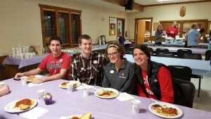 Pictured above (L-R): Jared Baxa, DPH-2, Daniel Putz, Courtney Putz, DPH-4, and Marklie Munroe, DPH-2, enjoy a break and sample the menu at the spaghetti dinner fundraiser.