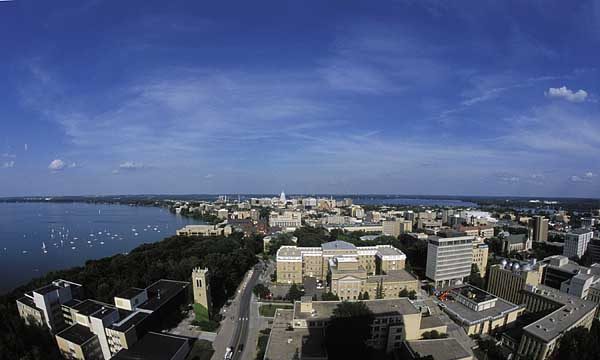 Aerial panned out shot over back of Bascom hall with view of lake edges