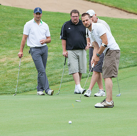 PAA Golf Tournament participants prepare to make a shot.
