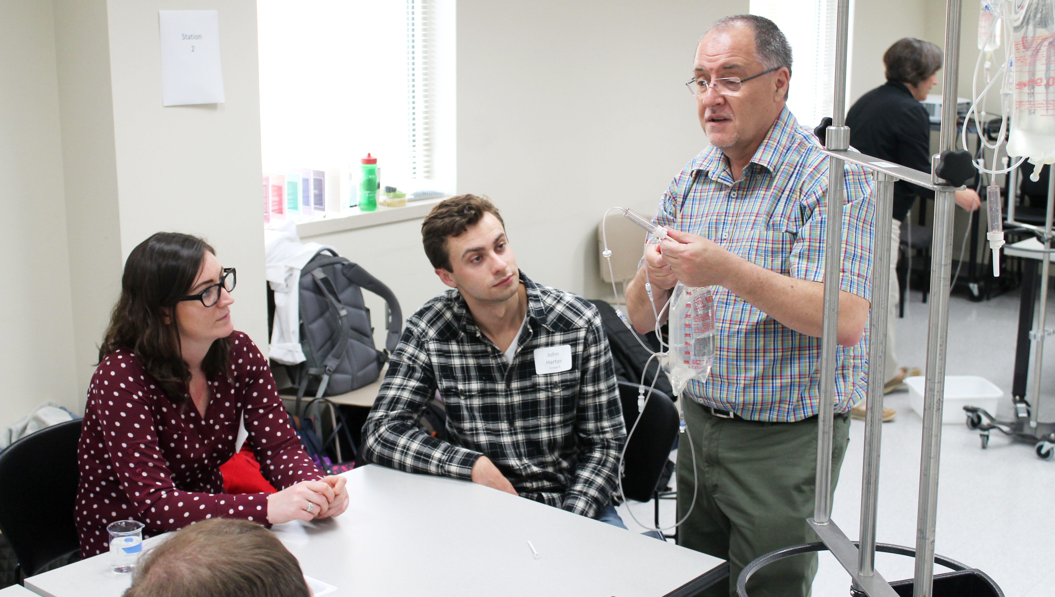 Mel de Villiers teaching students about medication administration via IV.