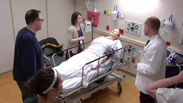 Alex Wontor and interprofessional health care team practicing with fake patient