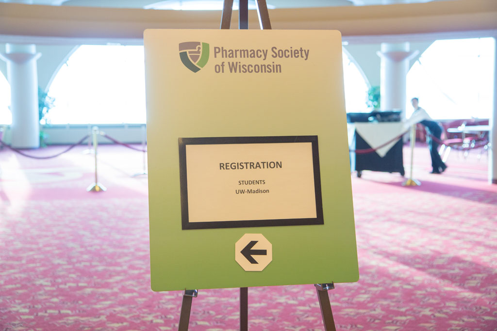 Sign board from Pharmacy Society of Wisconsin that says "Registration" with "Students UW-Madison" below it