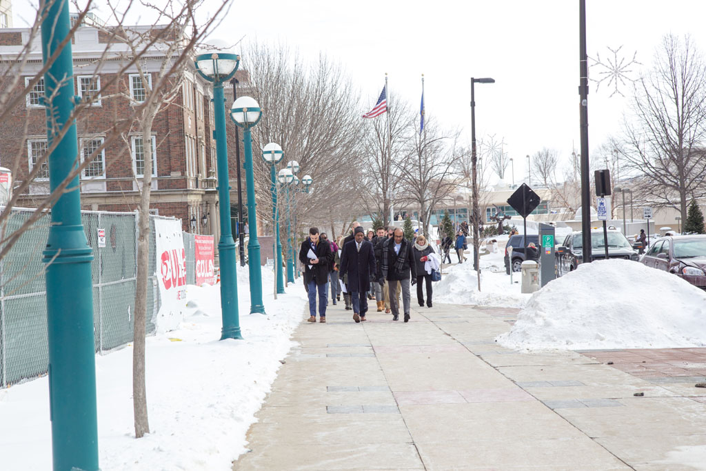 School of pharmacy group walking along sidewalk in cold weather