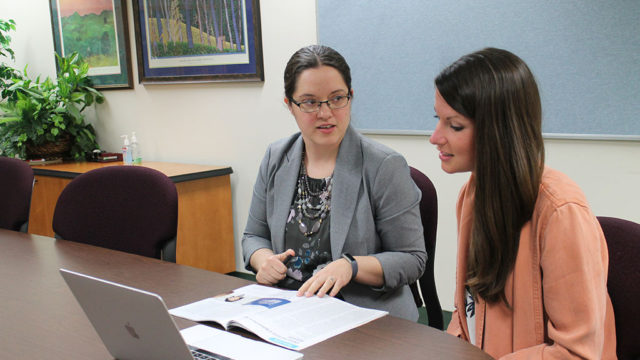 Amanda Margolis and Marklie Munroe working at table