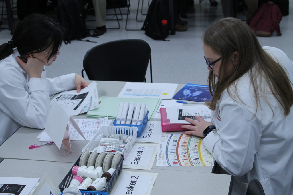 Students reading information sheet during asthma lab