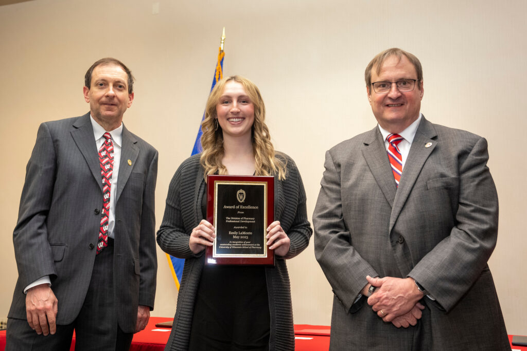 Emily LaMonte poses with her award and Dean Steve Swanson and Eric Buxton.
