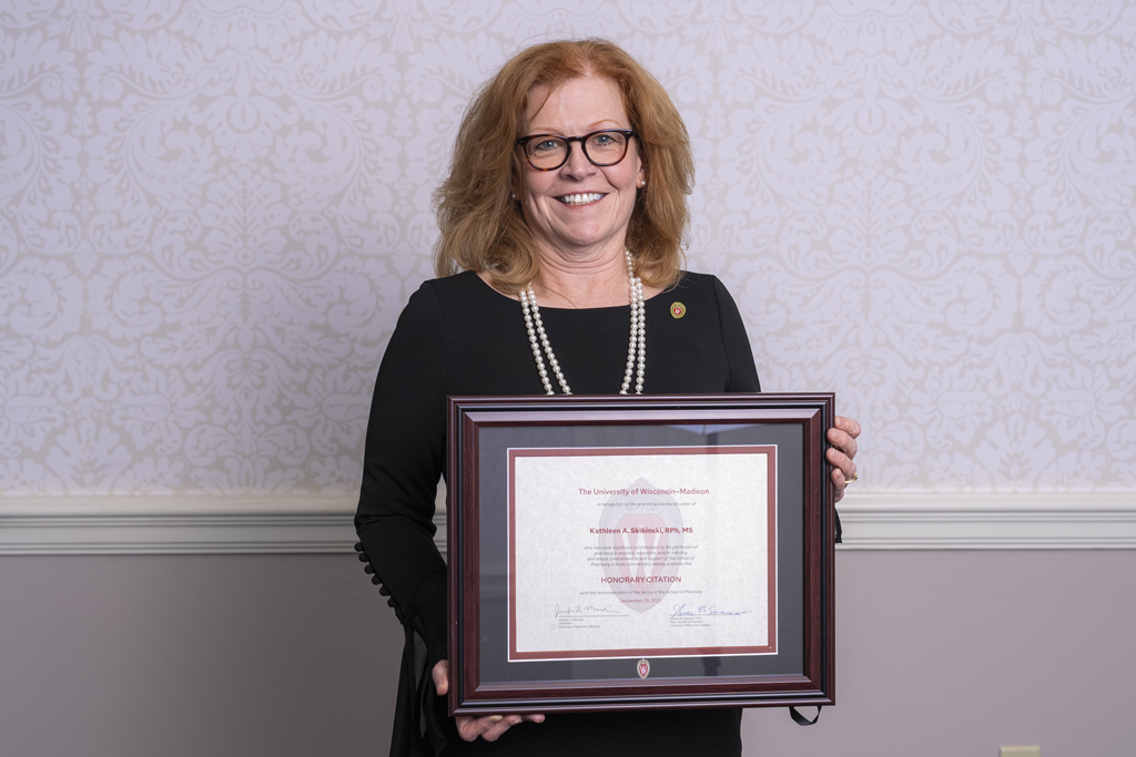 Kathleen Skibinski holding her 2023 Citation of Merit award.