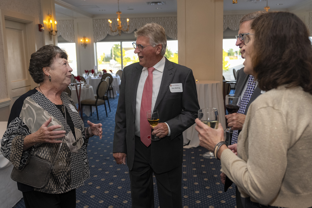 Don Behling, Arlene Iglar and two others engage in an animated conversation