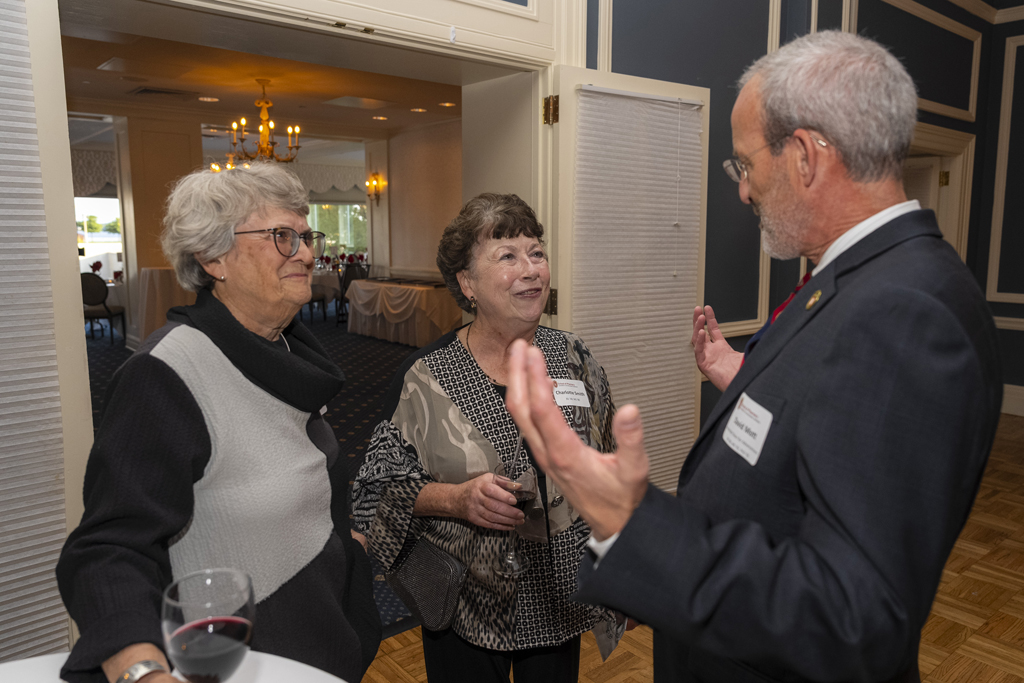 Dave Mott speaks with two Citations attendees