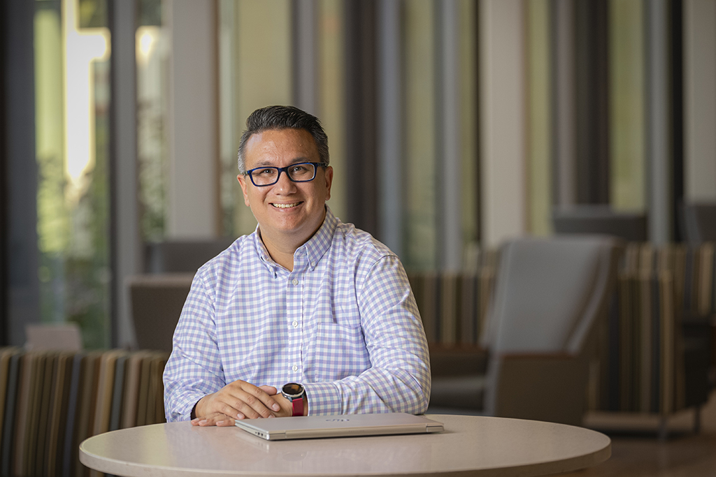 Jory Fleischauer smiles while sitting at a table