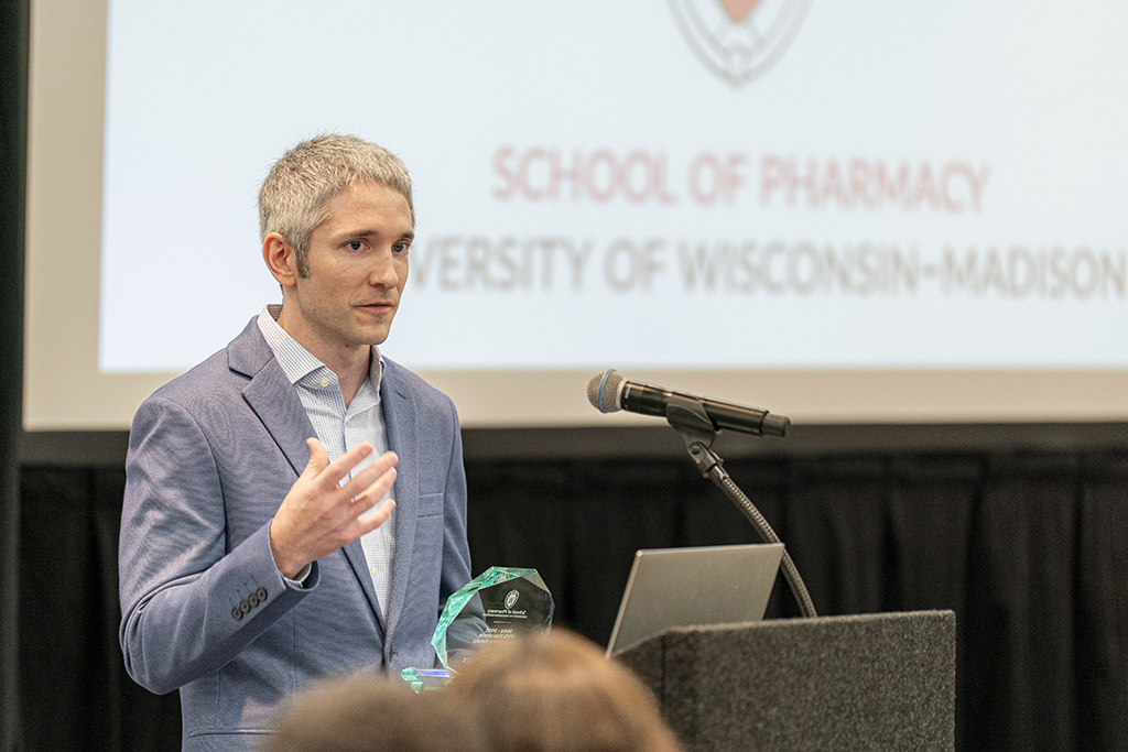 Dan Ricci accepts an award at a podium
