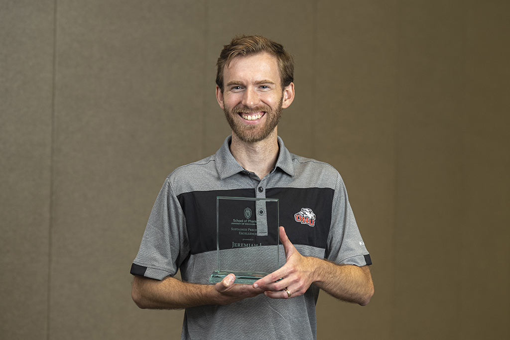 Jeremy Barnes poses with his award