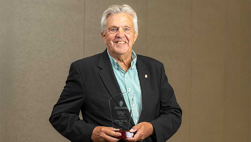 Terry Maves poses with his award