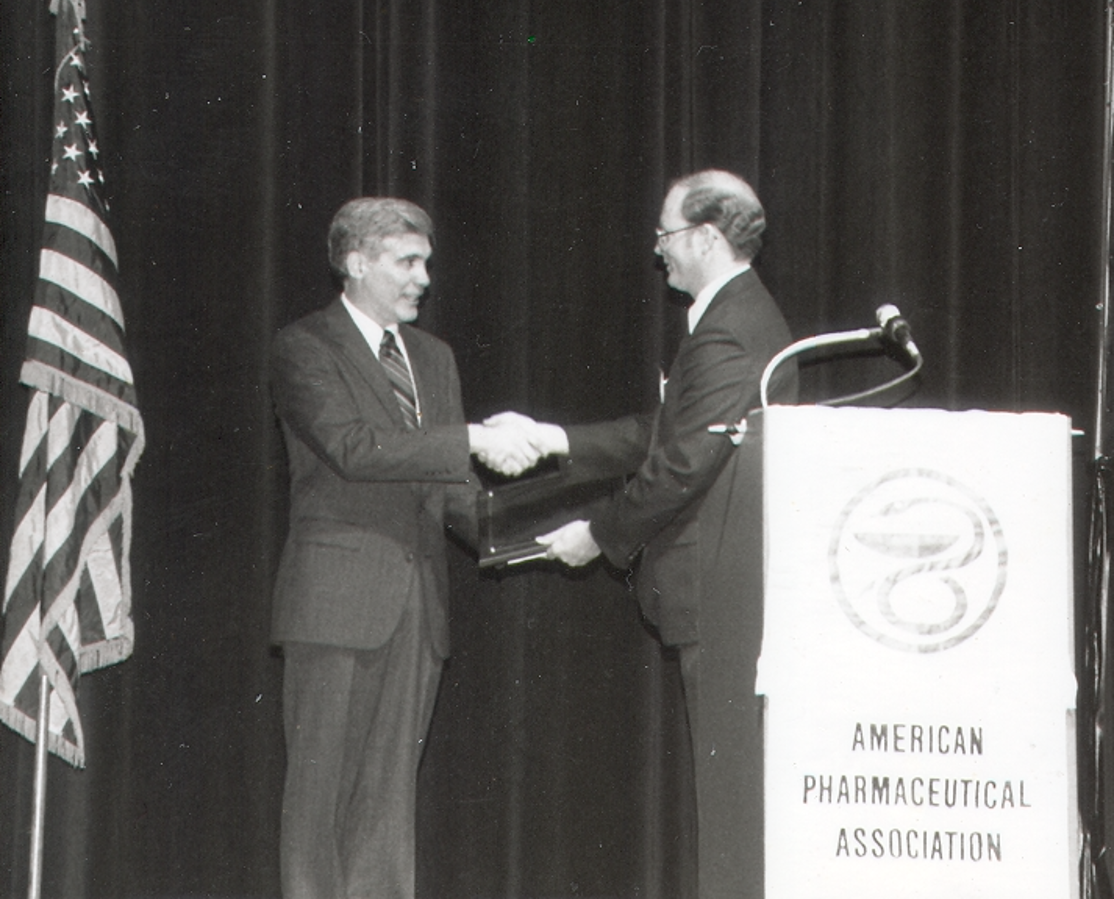 George Zografi accepting award from the American Pharmaceutical Association.