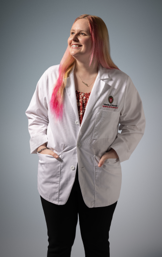 PharmD student Alyssa in a white coat