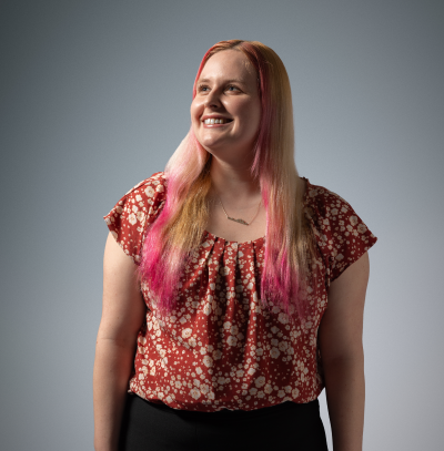 PharmD student in flowered blouse looks upward