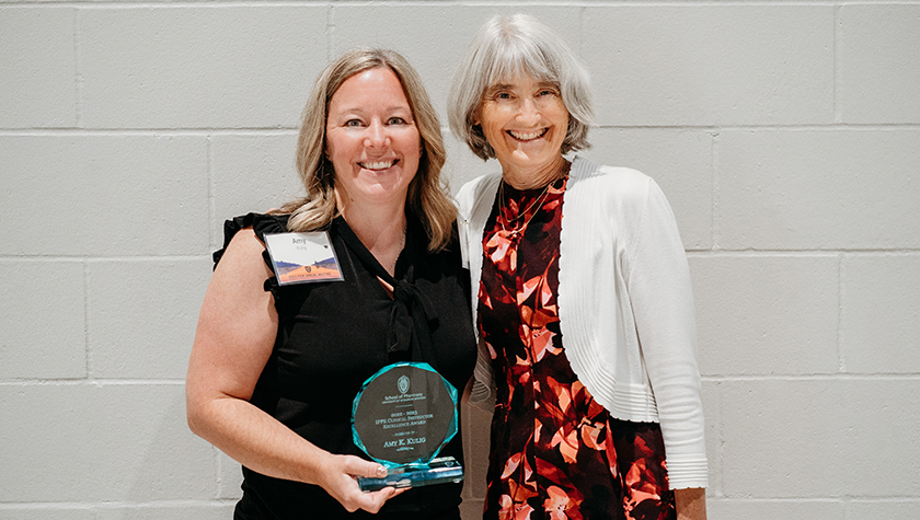 Amy Kulig holding her glass IPPE Clinical Instructor Excellence Award