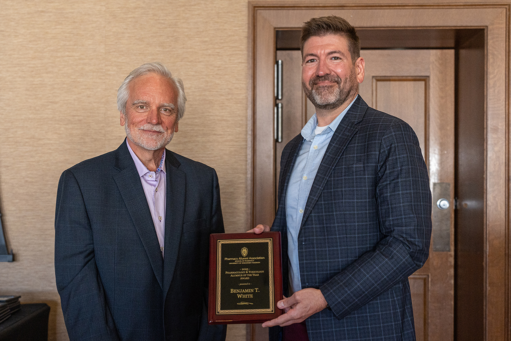Ben White and Jeff Johnson pose with the PharmTox Alum of the Year plaque