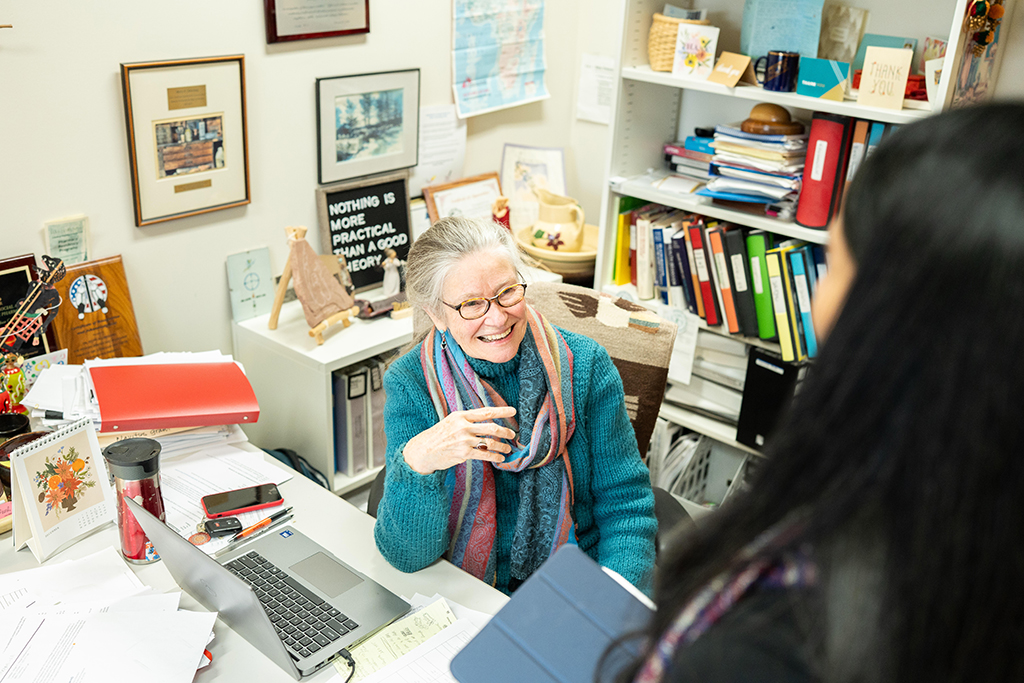 Betty Chewning speaks to a woman with black hair in her office