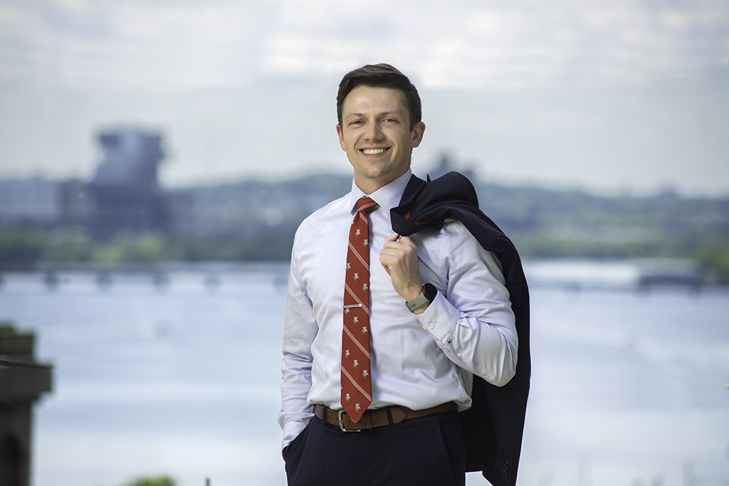 Connor Hanson outdoor portrait with his jacket over his shoulder