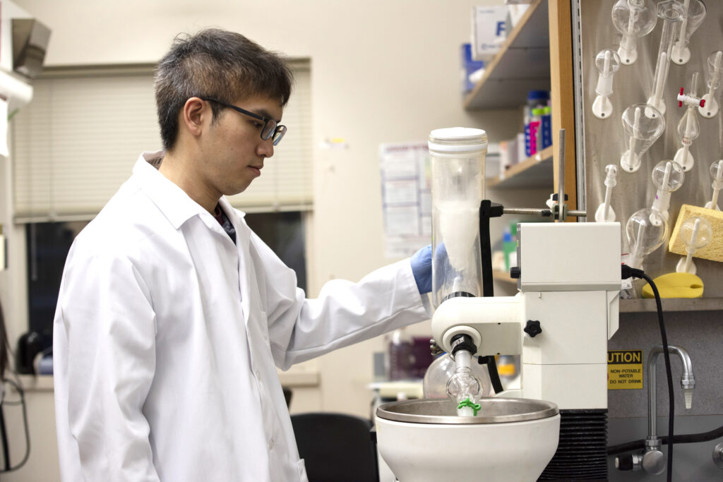 Peng-Kai Liu, a biophysics graduate student, works with a piece of specialized equipment called a rotary evaporator.