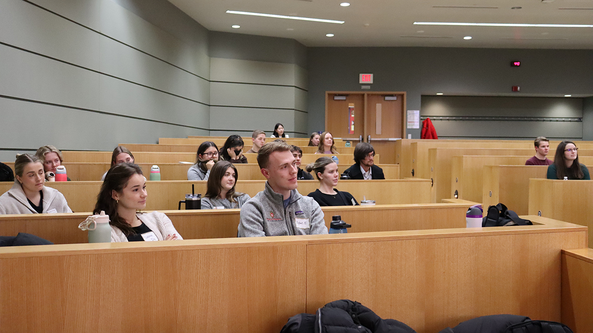 A group of PharmD students sit in a lecture hall