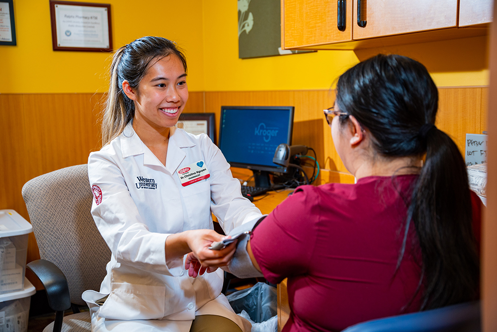 Christina Nguyen takes the blood pressure of a patient.