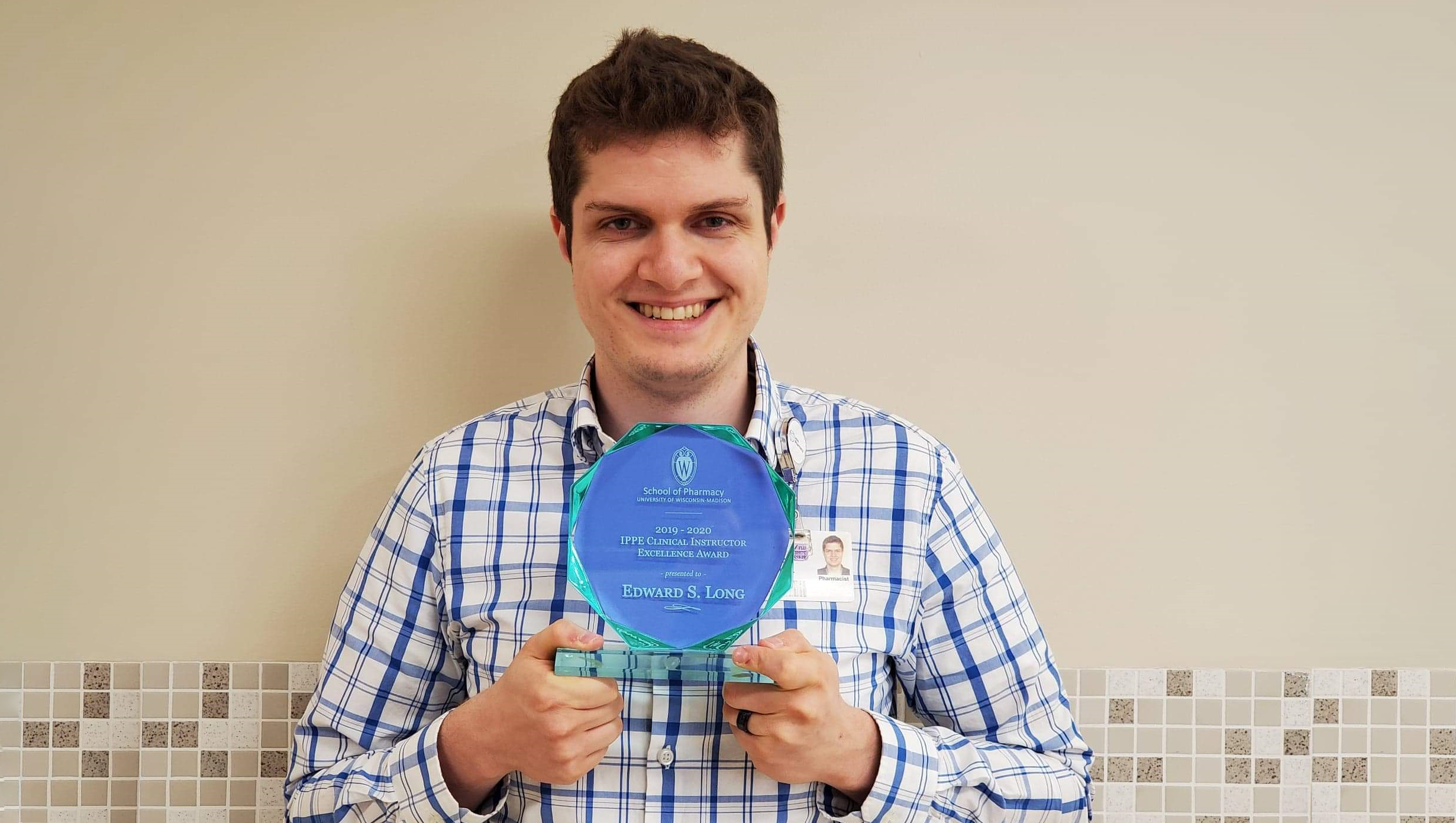Edward Long holding his IPPE Clinical Instructor Excellence Award