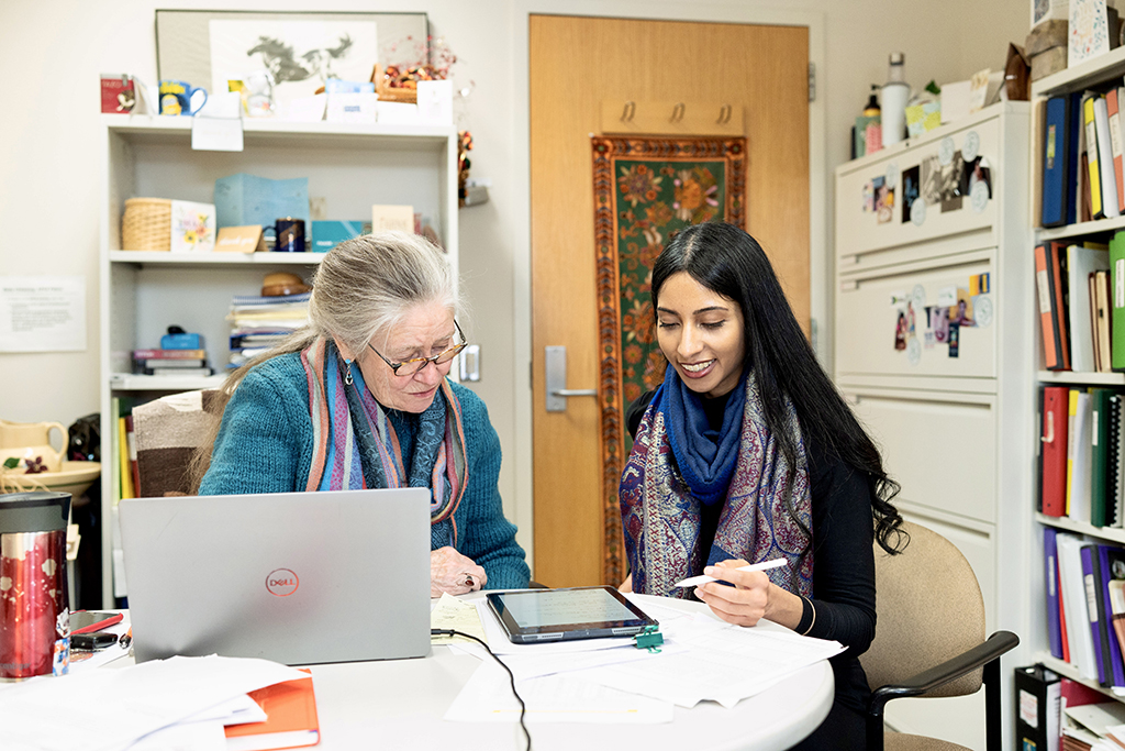 Betty Chewning and Apoorva Reddy look at a tablet together in Betty's office