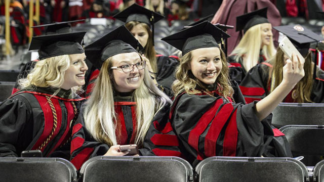 Pharmacy doctoral graduates Taryn Hinners, Lauren Arndt, and Amy Hoffman (left-right) take a selfie at the Kohl Center.