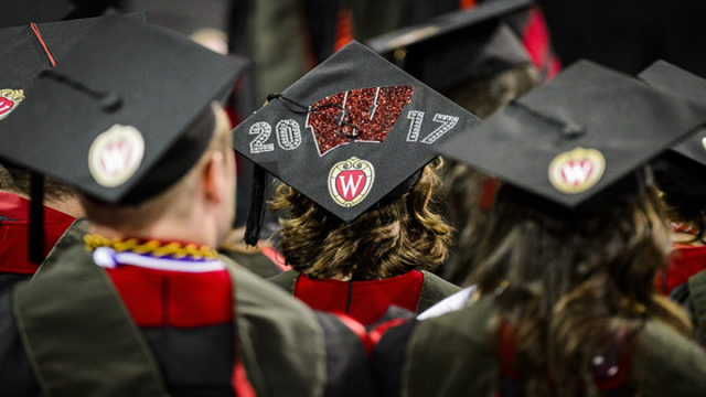 A graduate displays a decorated graduation cap.